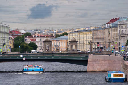 Saint-Petersburg, Russia - July 8, 2020: People in the tourist boats sail on The Fontanka River near The Lomonosov Bridgeのeditorial素材