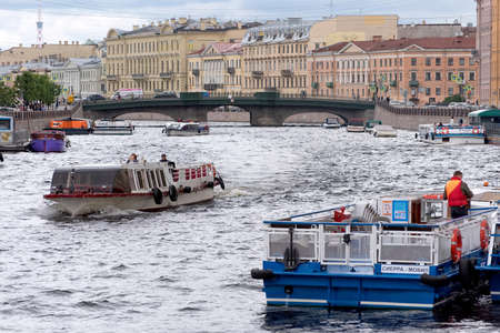 Saint-Petersburg, Russia - July 8, 2020: People in the tourist boats sail on The Fontanka River. On the background is Belinskogo Bridgeのeditorial素材