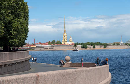 Saint-Petersburg, Russia - July 10, 2020: People near the bank of The Neva River on The Vasilyevsky Island opposite the Peter and Paul Fortressのeditorial素材