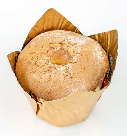 Orange muffin with candied fruits on a light background. Close up imageの写真素材