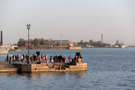 Kronstadt, Saint Petersburg, Russia - September 27, 2020: People look at the bay and take photographs at The Petrovskaya pierのeditorial素材