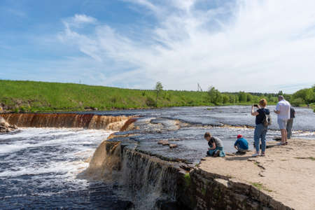 Ulyanovka village (Sablino). Leningrad Region. Russia - June 3, 2021: People take pictures of The Waterfall on The Tosna Riverのeditorial素材