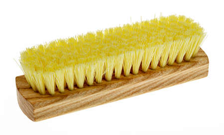 Wooden brush for clothes with yellow bristles on a white backgroundの写真素材