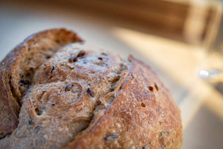 Fragment of the wheat round bread with sprouted grains and sunflower seeds