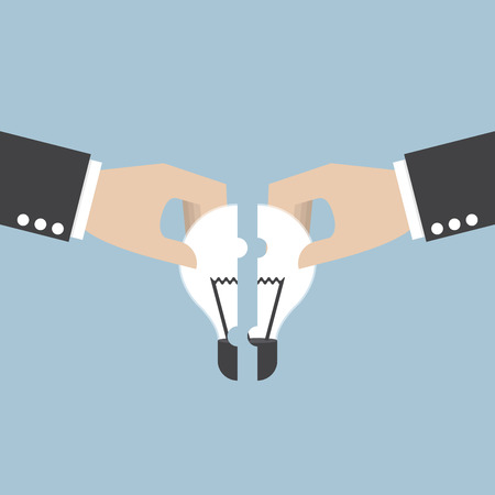 Businessman hands assembling pieces of light bulb jigsaw puzzle teamwork brainstorm concept VECTOR EPS10のイラスト素材
