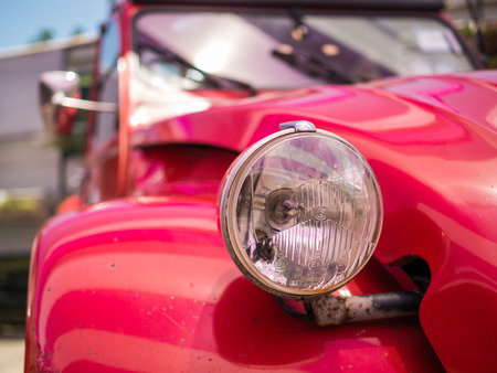 Close up detail of the headlight of an antique carの写真素材
