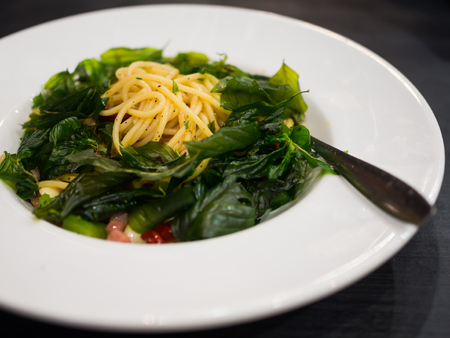 Tasty hot and spicy spaghetti with ham and veggie mixの写真素材