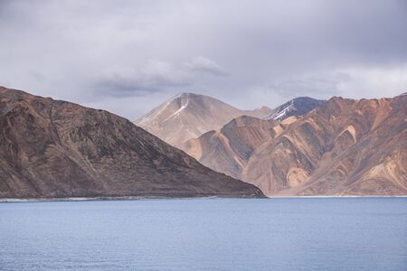 Pangong Lake with rocky mountains situated on the border with India and China in Ladakh region, State of Jammu and Kashmir, India.の写真素材