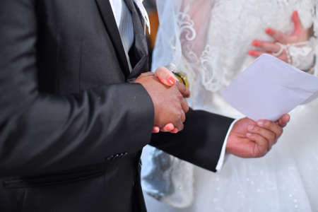 Joined hands of  groom and bride.の写真素材