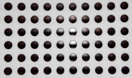 Texture set of black holes on the white plastic plateの写真素材