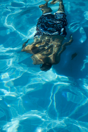 Man Reflection Diving in Swimming Pool Underwaterの写真素材