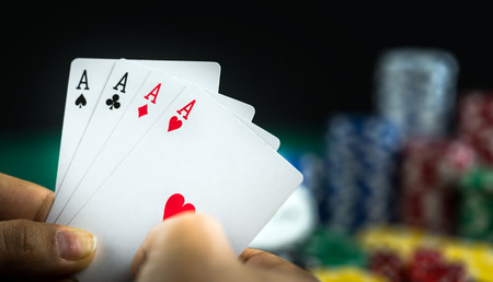 Gambling Hand Holding Best Game Card Series and Money Chips