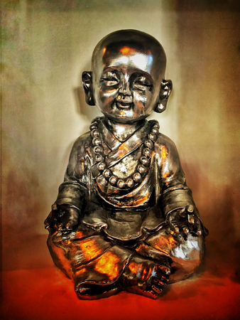Retro Grunge Buddha Sculpture and Candle Lightの写真素材