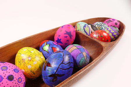 Colorful Easter Eggs in Wooden Plateの写真素材