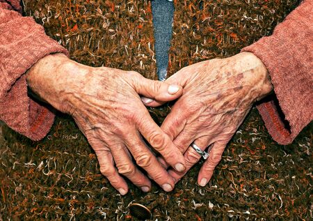 Old Age Woman Hands Detail on Hand Made Dressの写真素材