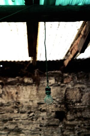 Lamp on a Cable in an Old House Room Photoの写真素材