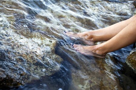 Young Woman Foot in the Clean Sea Water Photoの写真素材