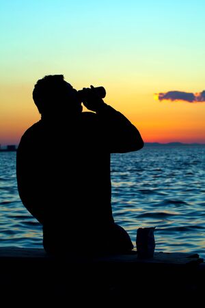 People Silhouette and the Sea in Sunset in the Afternoon Lightの写真素材