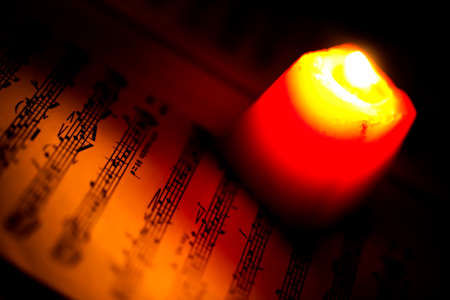 Music Notes Sheet in a Red Candle Light Photo