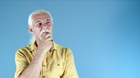 The Old Man Holds His Beard and Think Photoの写真素材