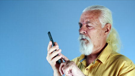 The White Haired Old Man Talks on the Cellphone Photoの写真素材