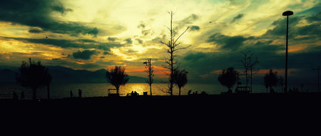 A high quality silhouette photograph showing moody sunset sky over the sea during a dramatic sunset....
