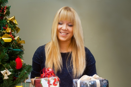 smiling happy girl with christmas giftsの写真素材