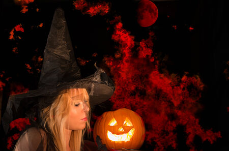 halloween witch and pumpking with fire on backgroundの写真素材