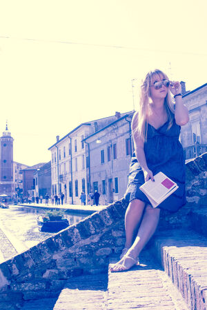 young single female tourist in an old Italian town retro look filterの写真素材