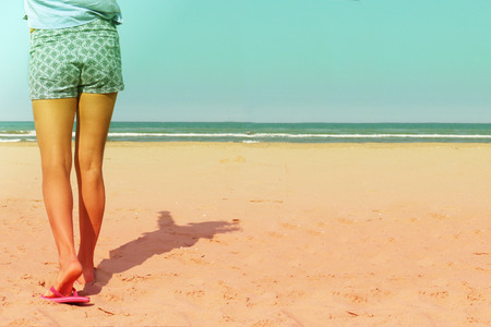 girl on beach walking to the seashoreの写真素材