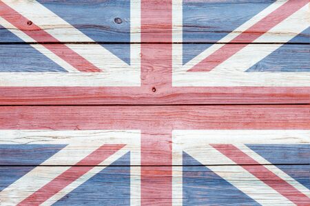faded british flag painted on rugged wooden backgroundの写真素材