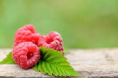fresh raspberry on natural wooden background