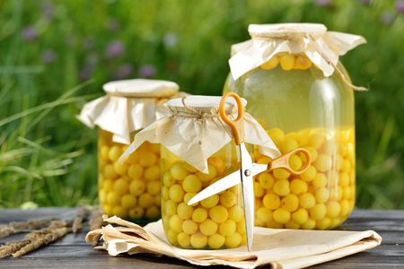 Preserved fruit, sour cherries compote. Canned fruit on wooden tableの写真素材