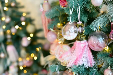 Decorated christmas tree with pink balls and light. Background new year, freespaceの写真素材
