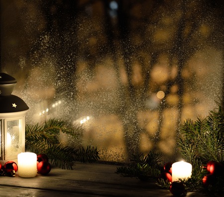 Christmas lantern with snowfall, candles, view from the window on the night street. Background lightsの写真素材