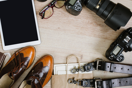 Photography hipster work table set with tablet, film, vintage shoes, lenses, supplies and digital film cameras. Top view with copy spaceの写真素材