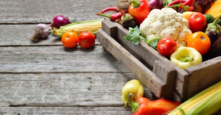 Raw organic set of fresh vegetables in wooded box background. Autumn harvest from the garden, long bannerの写真素材