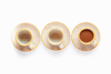 Coffee cups flat lay composition. Warm yellow and brown colors. Isolated on white background morning kitchen scene. Bright soft light. Design resources for social media postsの写真素材