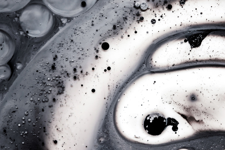 Unique ink background with small bubbles. Mix of black and white liquids. Creative realistic pattern. Space for text. Abstract artistic wallpaper. Small details, transparent and creamy combinationの写真素材