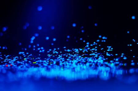 Colorful lights blurred glitter background. Abstract illuminated texture. Christmas, new year or birthday celebration. Night life photographyの写真素材