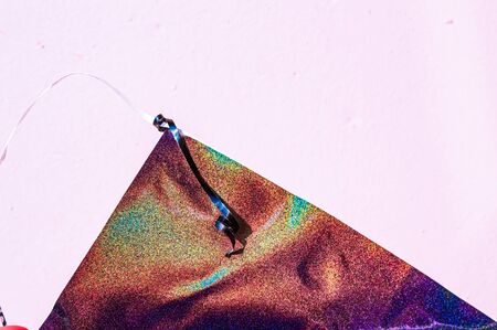 Holographic glitter texture on purple wall. Rainbow spectrum gradient. Shiny abstract background....