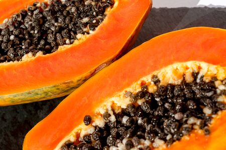 Fresh papaya exotic tropical fruit background. Sun day light illumination. Minimalistic summer flat...