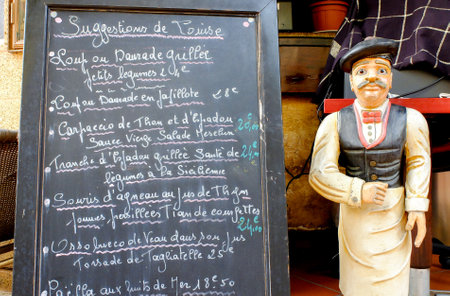 Menu blackboard with waiter statueのeditorial素材