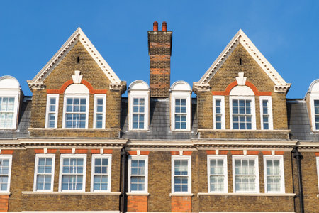 Facade of buildings in London with traditional roofs and a chimneyのeditorial素材