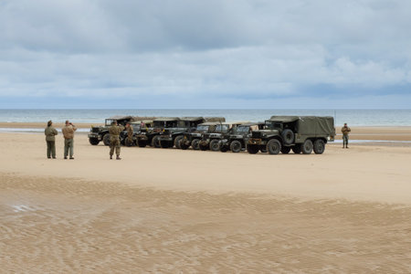 Omaha Beach, France, June 4th 2014: people and military vehicles at Omaha beach to celebrate the anniversary of d-day allied debarquement in Normandy.のeditorial素材
