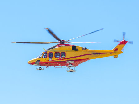 Turin, Italy, 9th july 2016: helicopter of Italian red cross medical emergency service 118 number, flying into a blue skyのeditorial素材