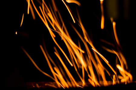 long fiery sparks at nightの写真素材