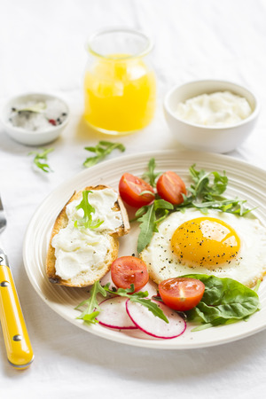 eggs with cherry tomatoes, arugula, radish and cheese sandwichの写真素材