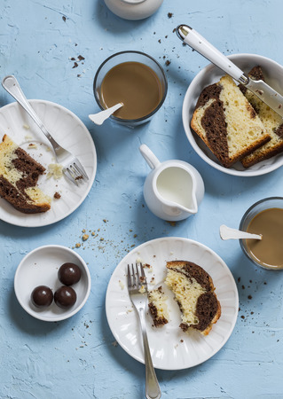 Coffee, cake, cream - breakfast or snack table, on a blue stone  backgroundの写真素材