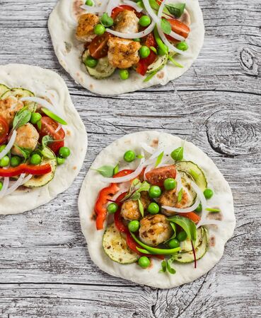 Chicken meatballs and fresh vegetables tortilla on a wooden rustic board. Healthy tasty foodの写真素材